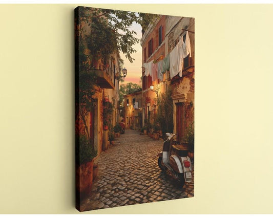 A cobblestone street lined with colorful buildings, clothes hanging from lines, and a parked motorcycle, creating a charming and picturesque scene.