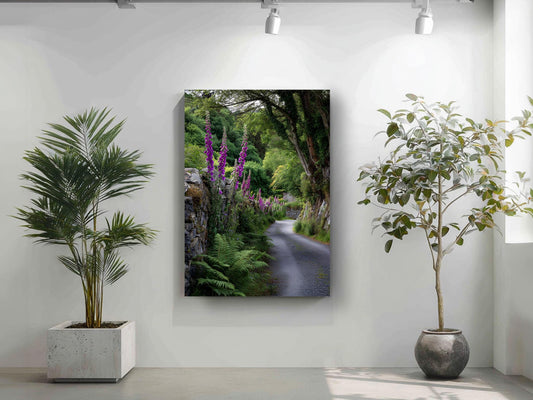 a serene garden scene with a winding path surrounded by lush greenery and vibrant purple flowers. Two potted plants, one on each side of the path, add to the tranquil atmosphere. A large canvas print depicting a picturesque garden path is displayed on the wall, creating a harmonious and visually appealing space.