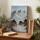 a wooden table with a painting of a snowy mountain village, surrounded by potted plants and books.