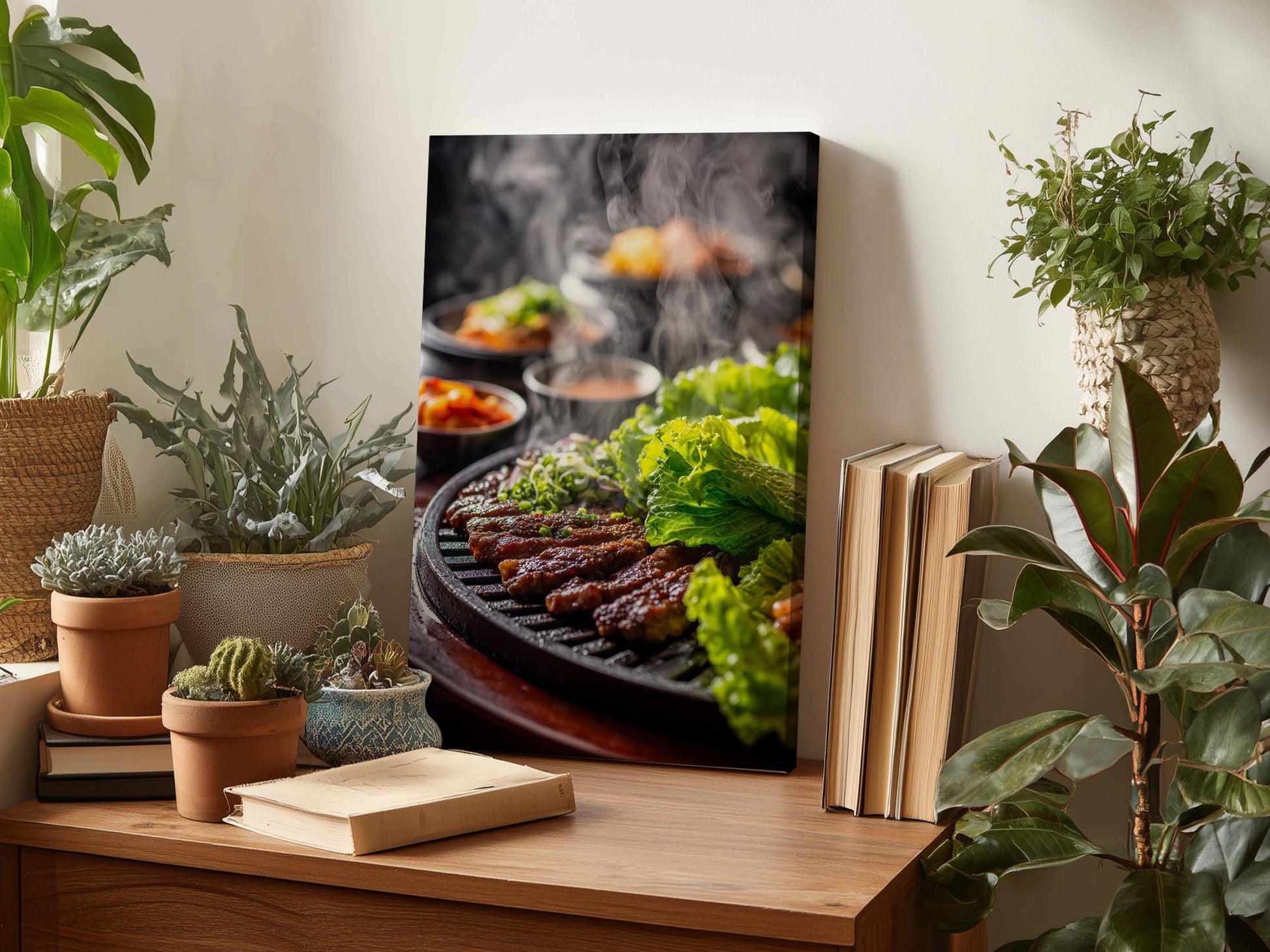 a wooden table with a framed photograph of a grill with meat and vegetables on it, surrounded by potted plants and books.