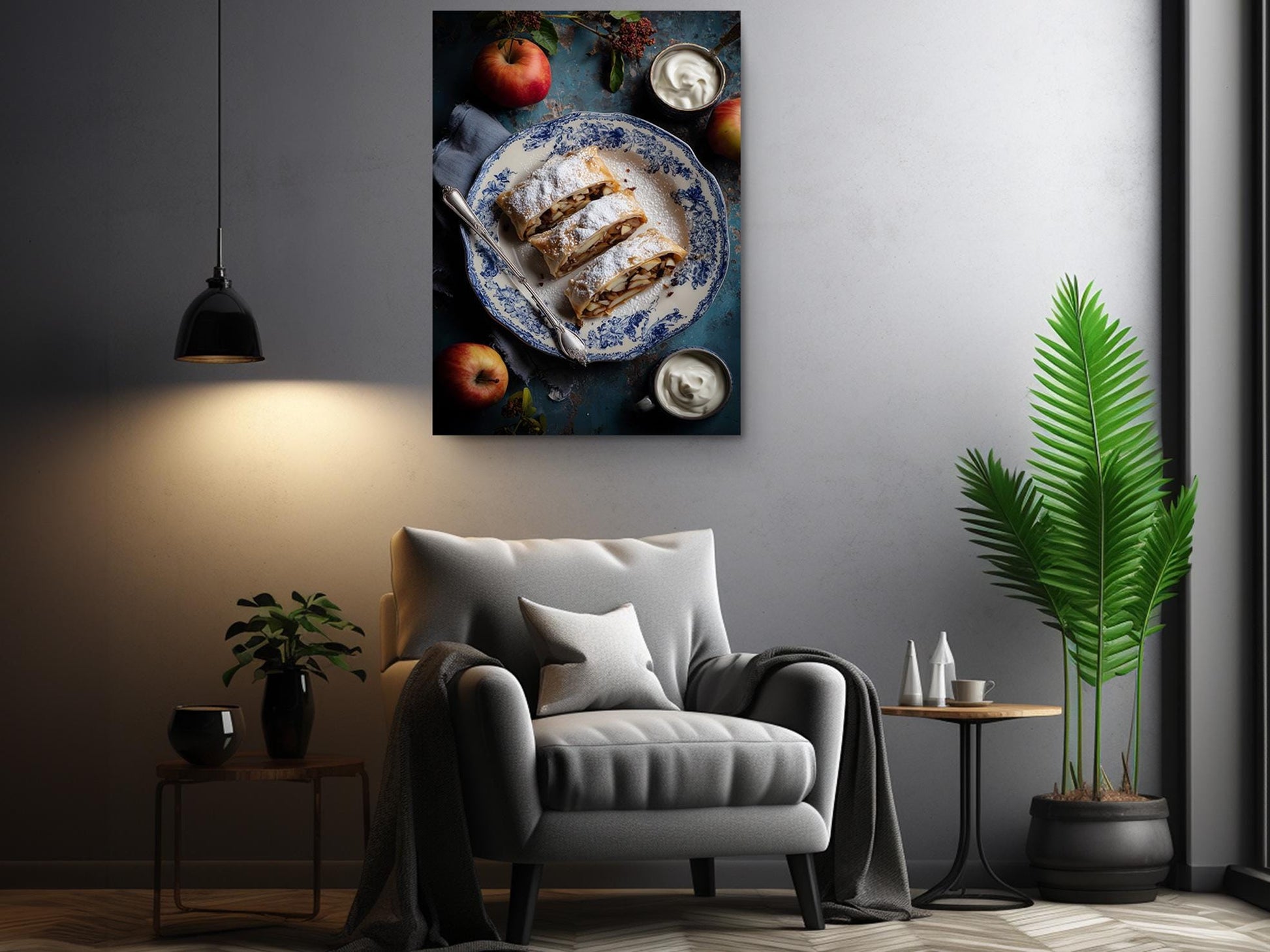 a cozy living room with a comfortable gray armchair, a wooden side table, and a potted plant. Above the armchair, there is a framed photograph of a plate of food, including a pastry and a fruit, creating a warm and inviting atmosphere.