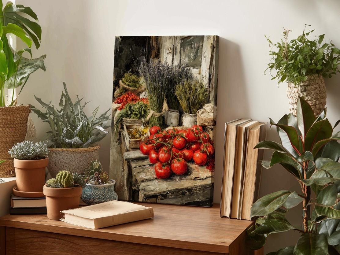 a wooden table with a variety of potted plants, a stack of books, and a painting of tomatoes and lavender.