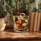 A painting of a croissant and coffee is displayed on a wooden table, surrounded by potted plants and books.