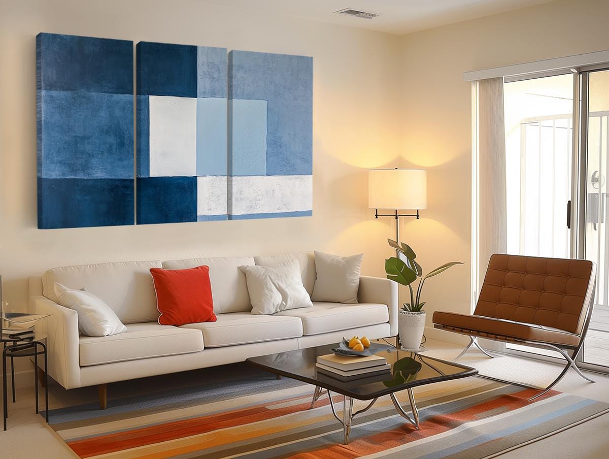 a living room filled with furniture and a painting on the wall