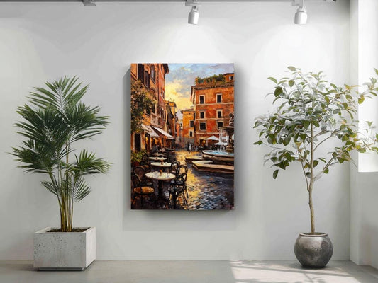 a painting of a street scene with buildings, tables, and chairs, hanging on a wall.