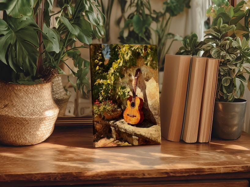 a wooden table with a framed painting of a guitar, surrounded by potted plants and books, creating a cozy and artistic atmosphere.