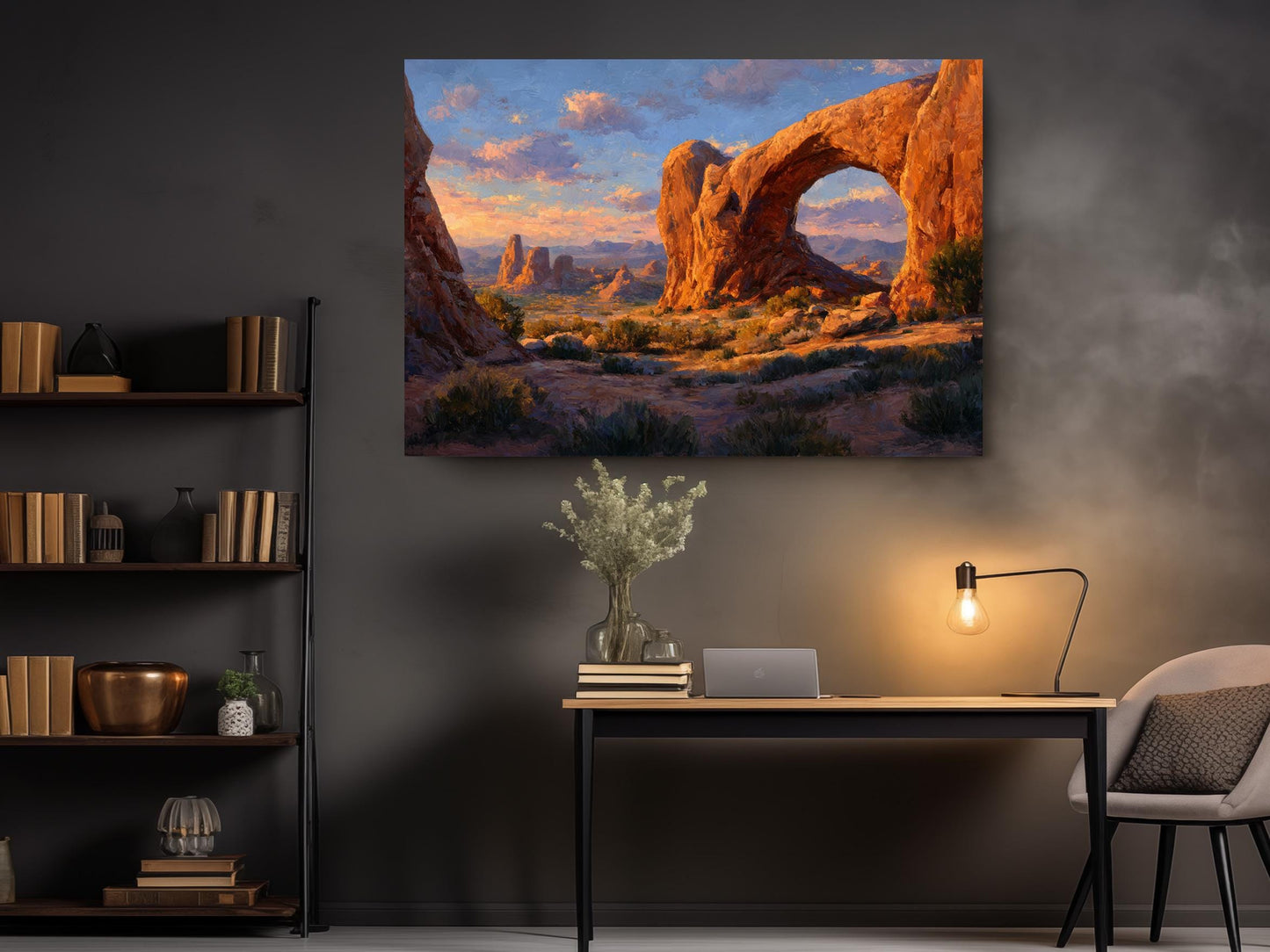 a large painting of a desert landscape with a prominent rock formation, hanging on a wall above a wooden desk with a lamp and some decorative items.