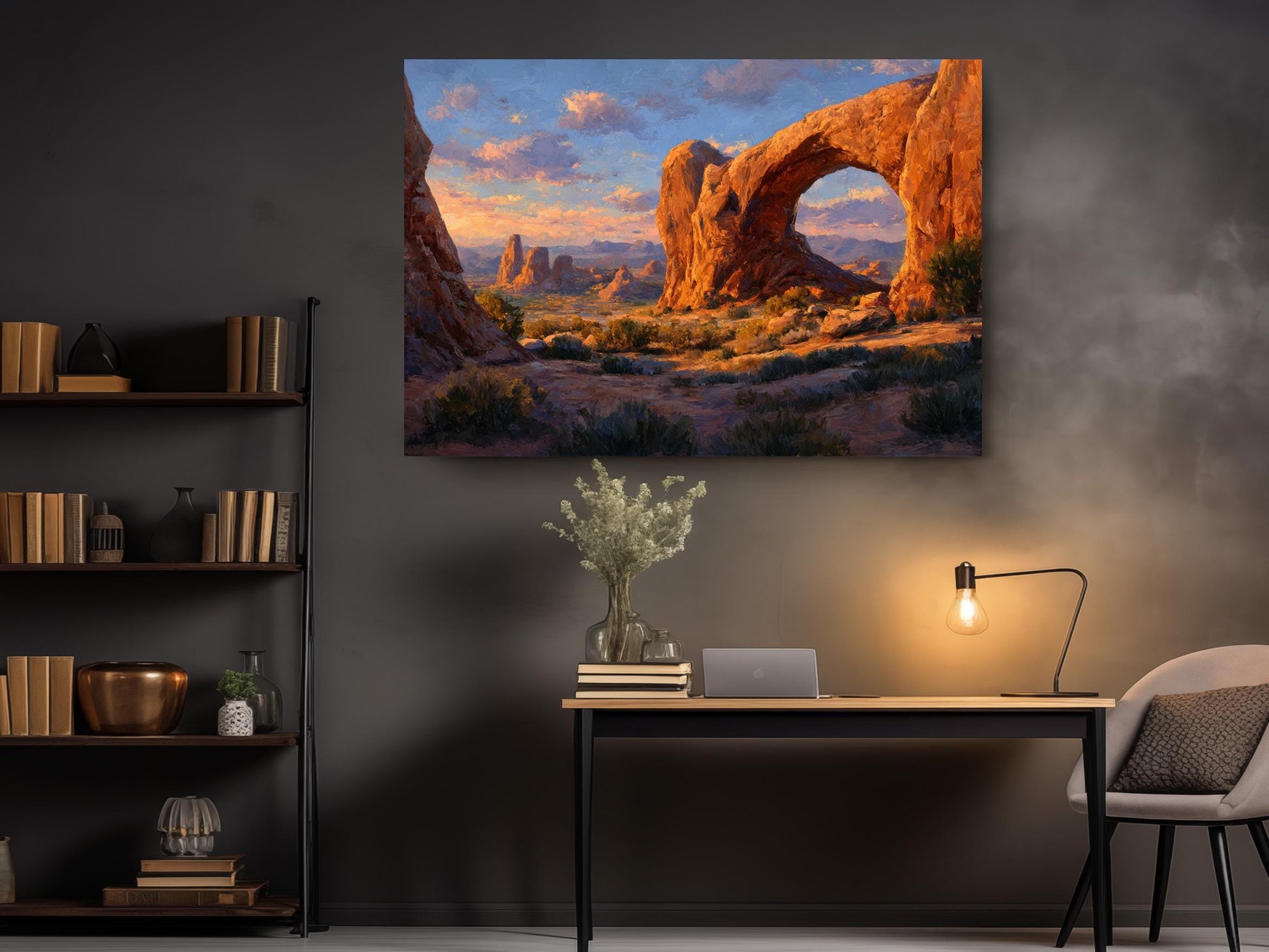 a large painting of a desert landscape with a prominent rock formation, hanging on a wall above a wooden desk with a lamp and some decorative items.