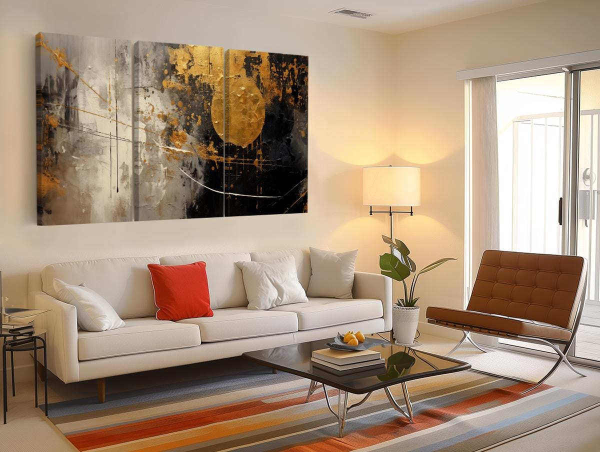 a living room with a white couch and a painting on the wall