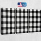 a black and white checkered wall hanging on a wall