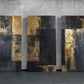 a group of three black and gold paintings on a wall