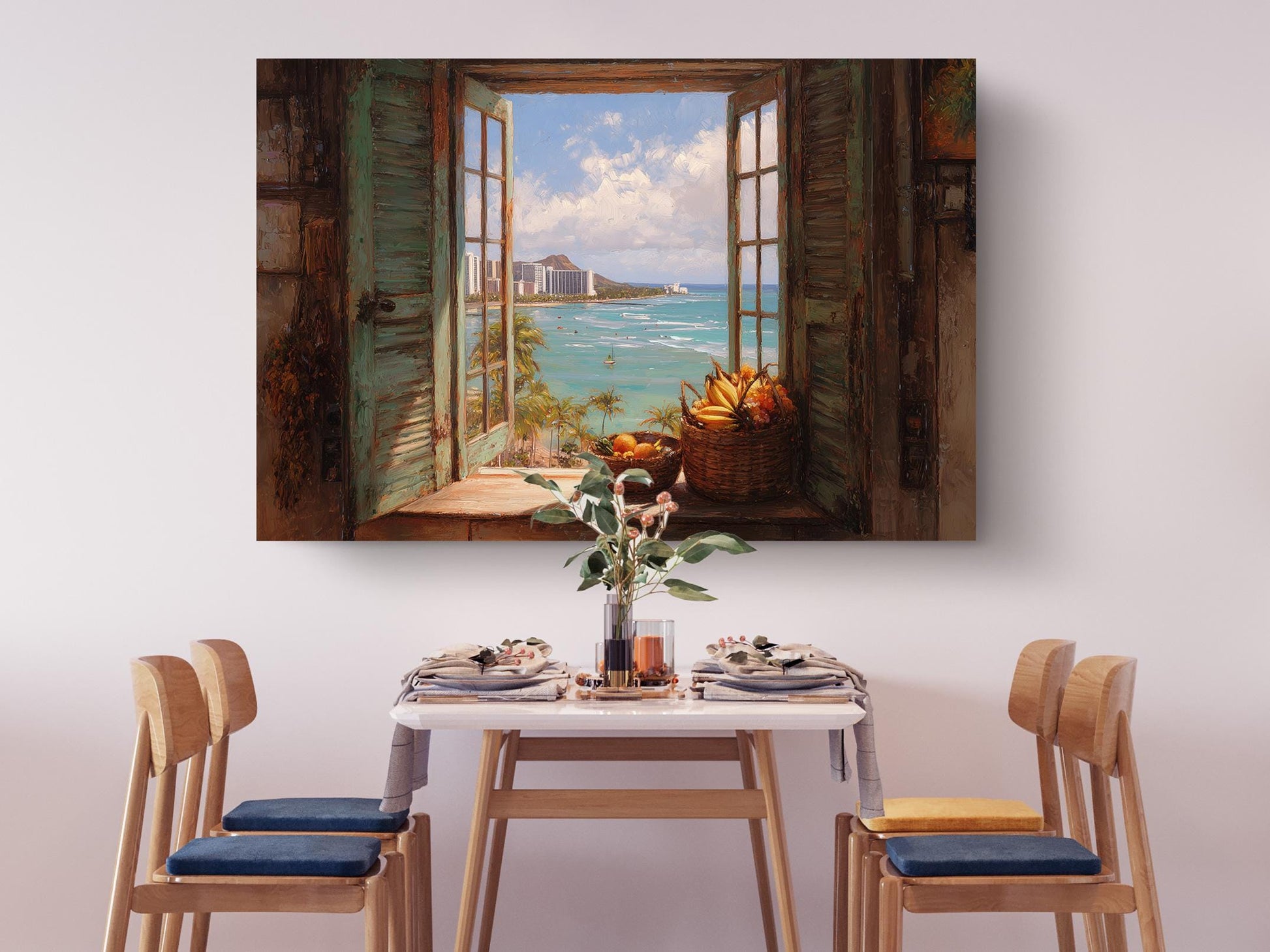 a dining room with a table set for four, featuring a vase of flowers and a basket of fruit. Above the table, there is a large painting of an open window overlooking a beach with a cityscape in the background.