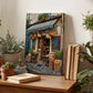 a wooden table with a painting of a quaint bakery shop displayed on it. The table also has several potted plants, books, and other decorative items.
