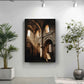 a large framed picture of a church with arched windows, hanging on a white wall between two potted plants.