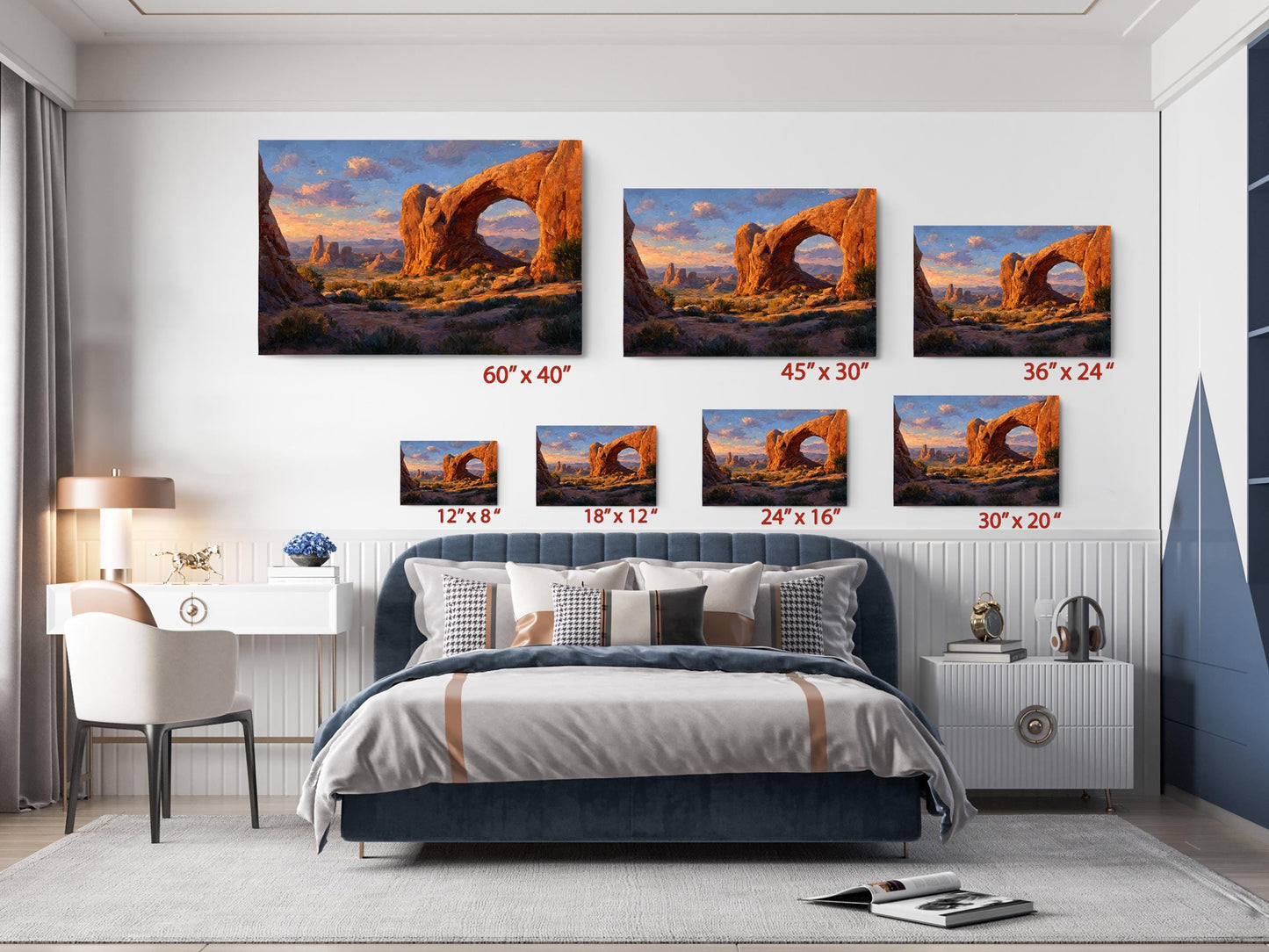 The image is a bedroom with a large bed, a desk, and a chair. Above the bed, there are six framed landscape photographs of desert scenes, each with a different size and resolution. The photographs are arranged in a grid-like pattern, with each row representing a different size and each column representing a different resolution. The photographs depict various desert landscapes, including rock formations, sand dunes, and mountains.