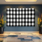 a black and white checkered wall hanging on a blue wall