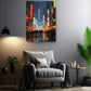 a modern living room with a gray armchair, a wooden side table, and a potted plant. Above the armchair, there is a large painting of a cityscape with colorful lights and buildings.