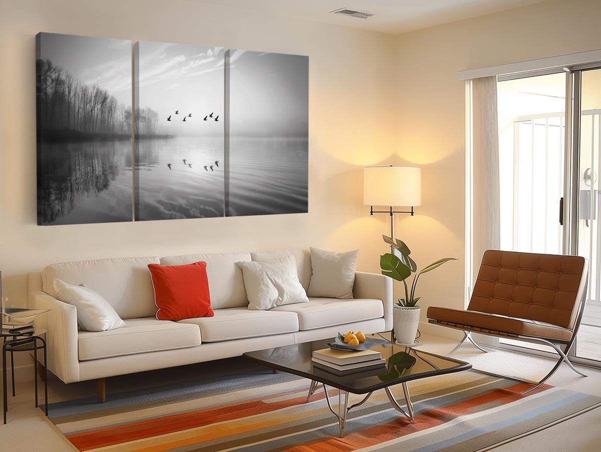 a living room filled with furniture and a painting on the wall