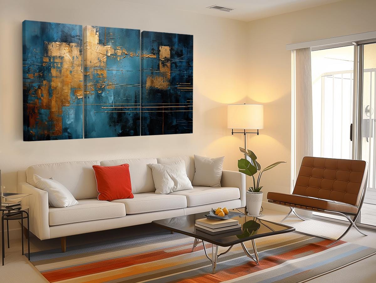 a living room with a white couch and a painting on the wall