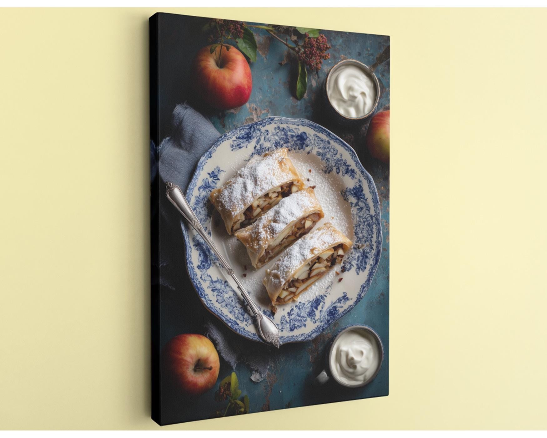 A blue and white patterned plate holds a pastry, accompanied by a bowl of whipped cream and two whole apples on a table.