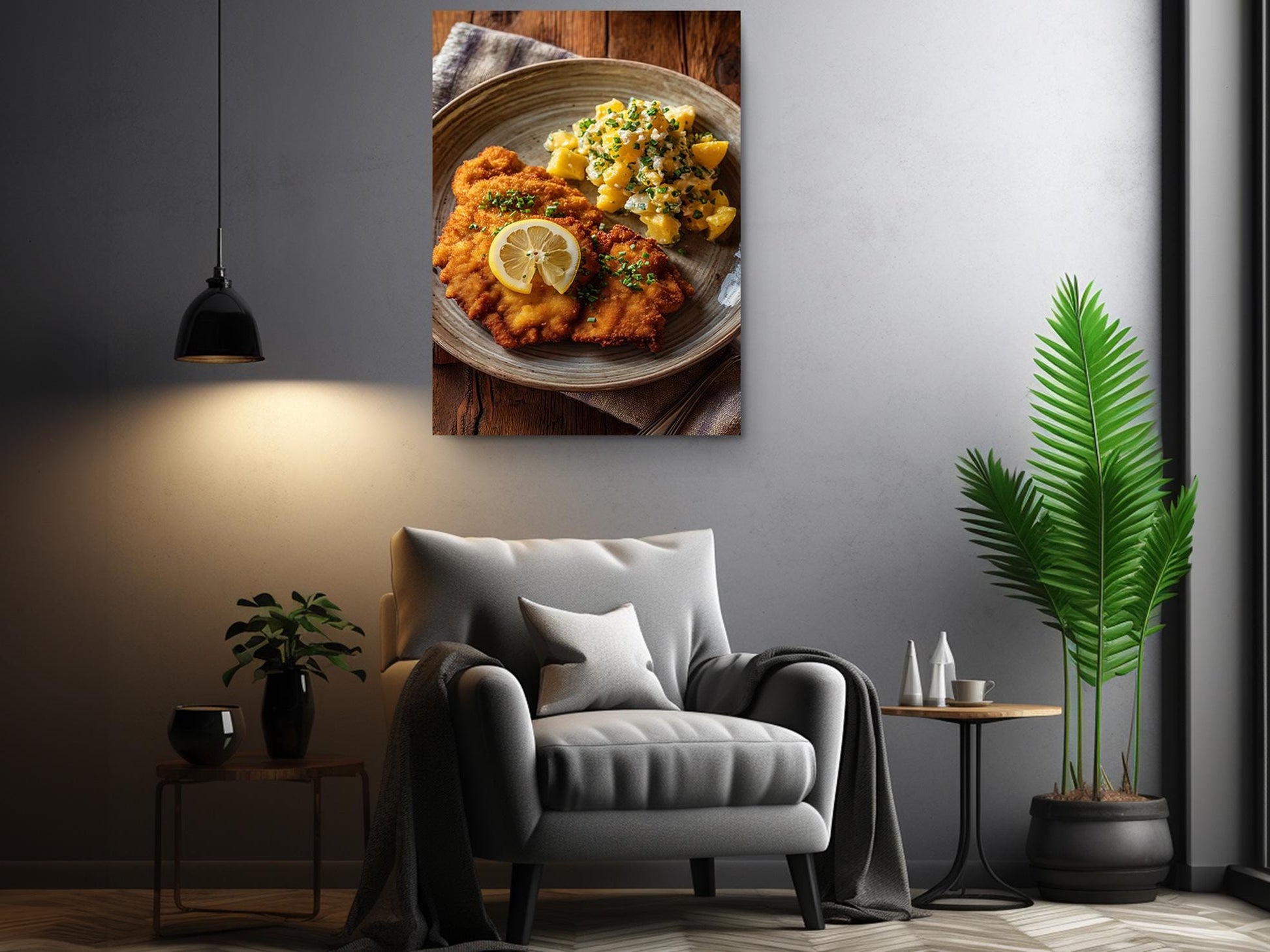 a cozy living room with a comfortable gray armchair, a wooden side table, and a potted plant. Above the armchair, there is a framed photograph of a plate of food, including a piece of meat and a side of vegetables.