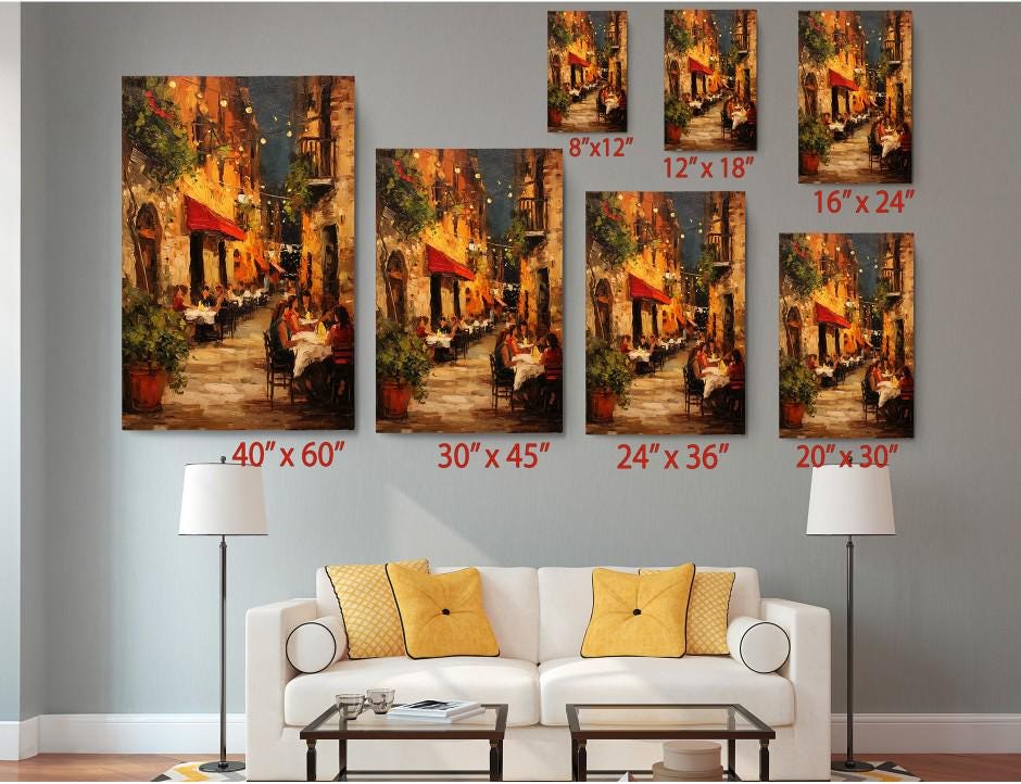 The image is a living room with a white sofa and a coffee table. Above the sofa, there are seven framed paintings of a street scene, each with a different size and resolution. The paintings are arranged in a grid-like pattern on the wall, with each one depicting a different view of the same street scene. The sizes of the paintings vary, ranging from 6&#39;x12&quot; to 24&#39;x36&quot;.