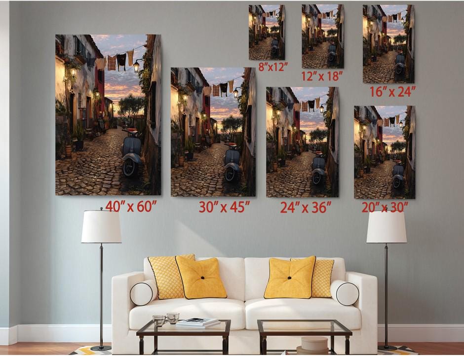 The image is a living room with a white sofa and a coffee table. Above the sofa, there are six framed pictures of a cobblestone street at sunset, each with a different size and resolution. The pictures are arranged in a grid-like pattern on the wall, with each one depicting a different angle and perspective of the cobblestone street and the sunset.