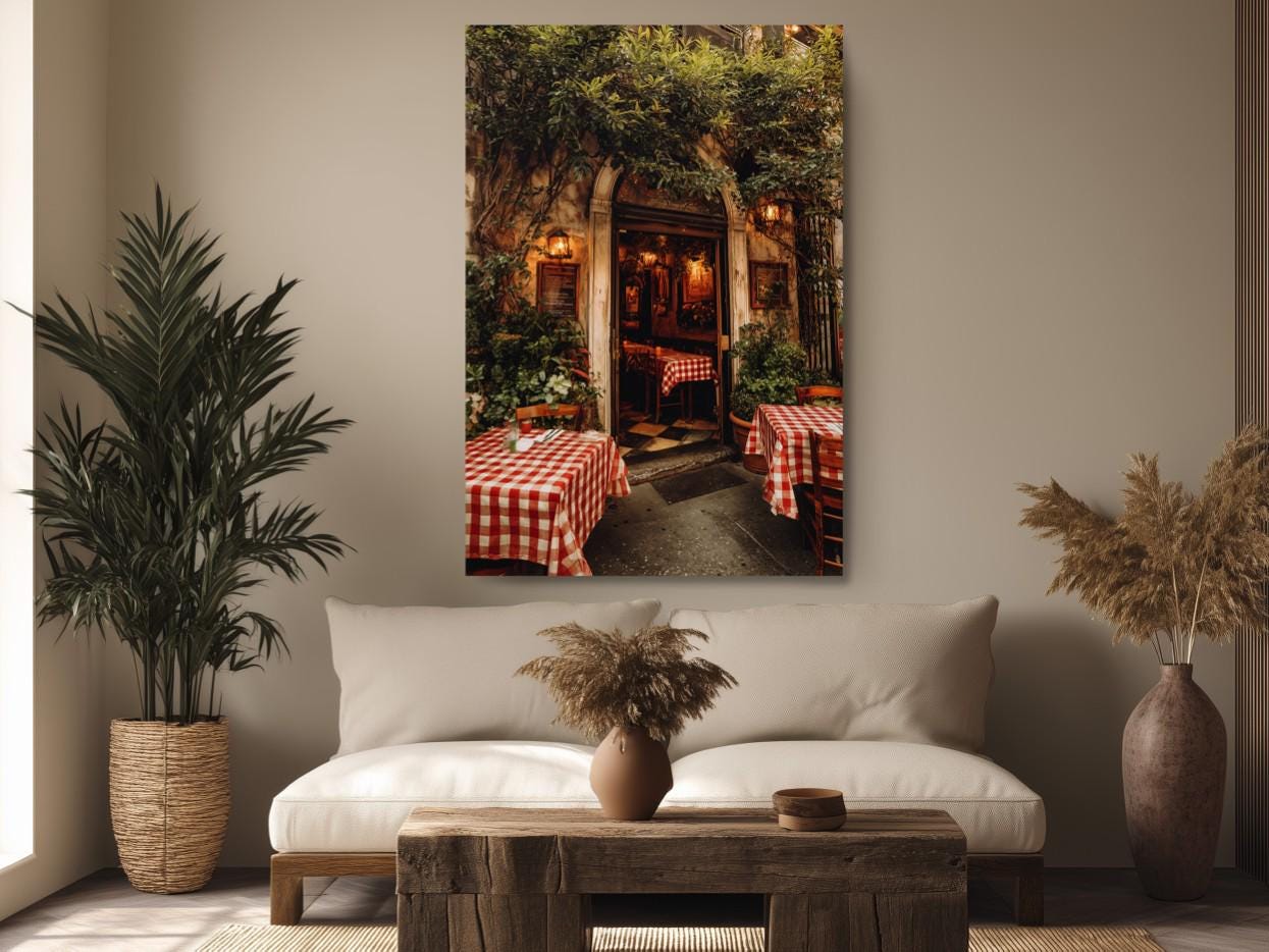 a cozy restaurant setting with a red and white checkered tablecloth, surrounded by lush greenery and a wooden table.