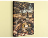 A picnic scene with a bottle of wine, a glass, bread, cheese, and grapes set on a checkered blanket, with a scenic backdrop of trees and a cloudy sky.