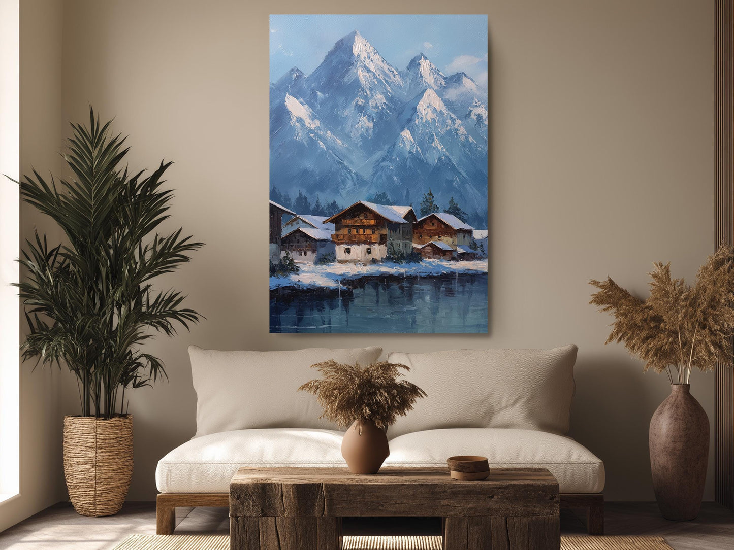 a cozy living room with a large painting of a snowy mountain village hanging on the wall. The painting depicts a picturesque winter scene with a quaint village nestled in the mountains, surrounded by snow-covered peaks. The room is decorated with a comfortable sofa, a wooden coffee table, and potted plants, creating a warm and inviting atmosphere.