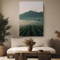 a serene living room with a large painting of a field of crops hanging on the wall, a sofa, a coffee table, and two potted plants.