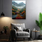 a cozy living room with a gray armchair, a wooden side table, and a potted plant. Above the armchair, there is a framed photograph of a mountainous landscape with a misty, colorful scene.