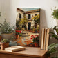a wooden table with a painting of a courtyard scene, surrounded by potted plants and books.