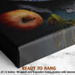 The image is a close-up of a black canvas print featuring a vibrant red apple and a green plant, with a text overlay that reads &quot;READY TO HANG&quot; and provides the dimensions of the print as &quot;-1.5 inches&quot; and &quot;wrapped over a wooden frame.&quot;