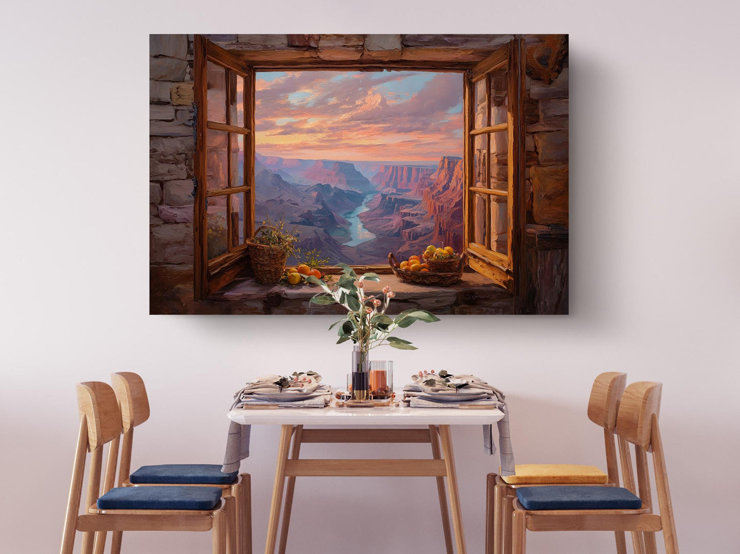 a dining table set with plates, silverware, and a vase of flowers, with a painting of a scenic mountain view hanging above it.