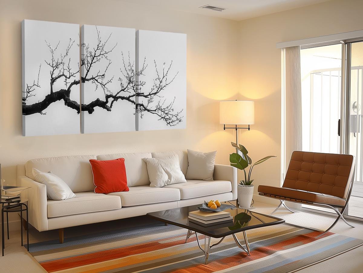 a living room filled with furniture and a painting on the wall