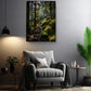 a serene indoor setting with a cozy gray armchair, a wooden side table, and a potted plant. Above the armchair, a framed photograph of a forest path with moss-covered rocks is displayed on the wall, creating a tranquil and natural atmosphere.