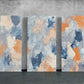 three abstract paintings on a concrete wall