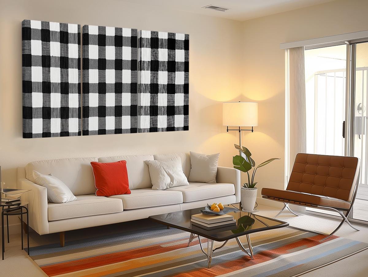 a living room filled with furniture and a painting on the wall