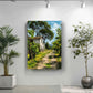 a painting of a house on a path surrounded by trees, hanging on a white wall. Two potted plants are placed on either side of the painting, creating a serene and natural atmosphere in the room.