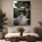 a serene Japanese garden scene with a traditional wooden gate and a stone path leading to a temple. The garden is surrounded by lush greenery, including a variety of potted plants. The room has a comfortable seating area with a sofa and a wooden coffee table, and a large window allows natural light to illuminate the space.