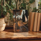 a wooden table with a framed painting of a scenic countryside landscape, surrounded by potted plants and books.