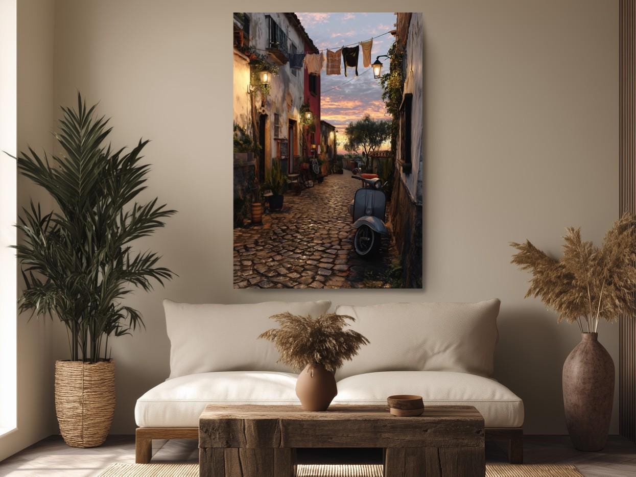 a cozy living room with a large painting of a cobblestone street scene hanging on the wall. The painting features a bicycle parked on the street, a wooden bench, and a potted plant. The room is decorated with a white sofa, a wooden coffee table, and a vase with dried flowers. The overall atmosphere of the room is warm and inviting, with the painting serving as a focal point.