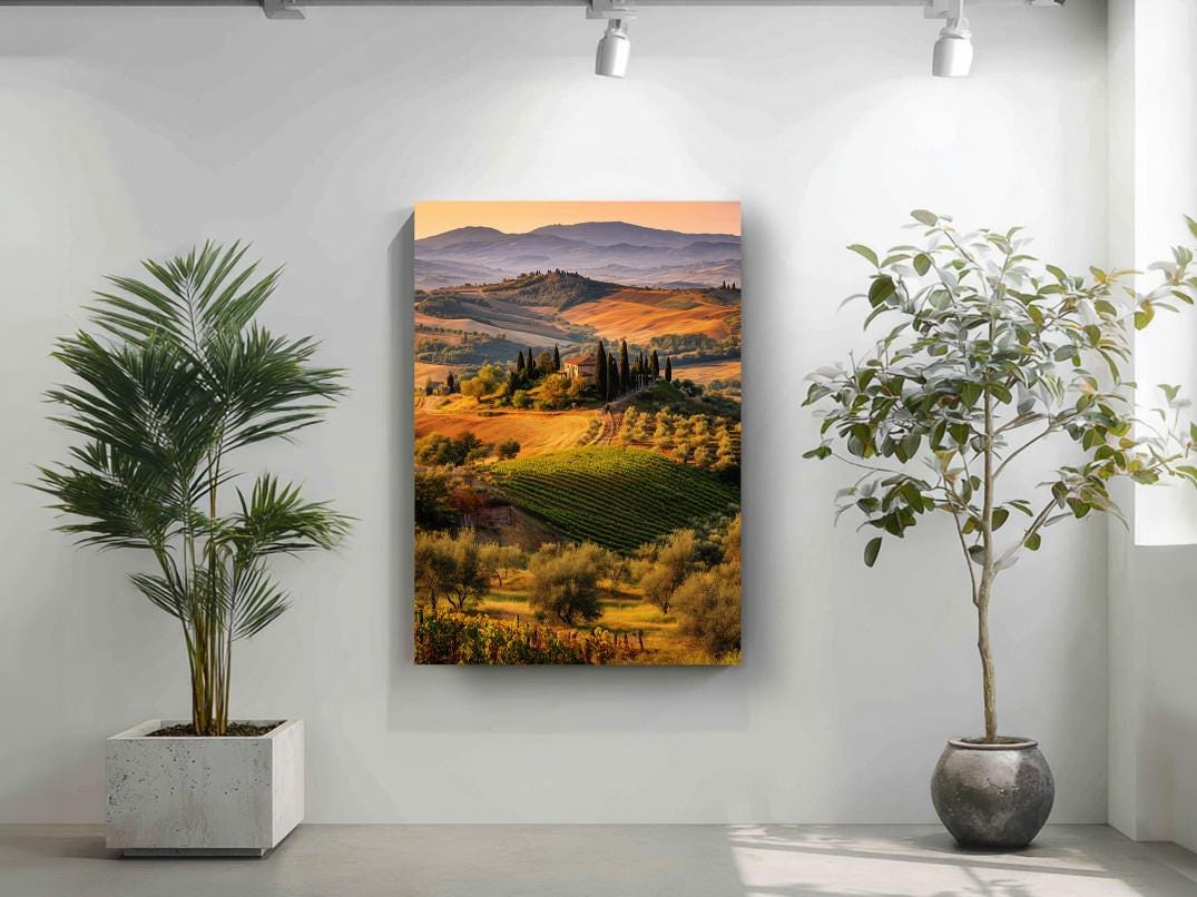 a large landscape painting hanging on a wall, with a potted plant to the left and a potted plant to the right.