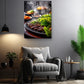 a cozy living room with a comfortable gray armchair, a wooden side table, and a potted plant. Above the armchair, there is a framed photograph of a grill with various food items, including what appears to be grilled vegetables and meat.