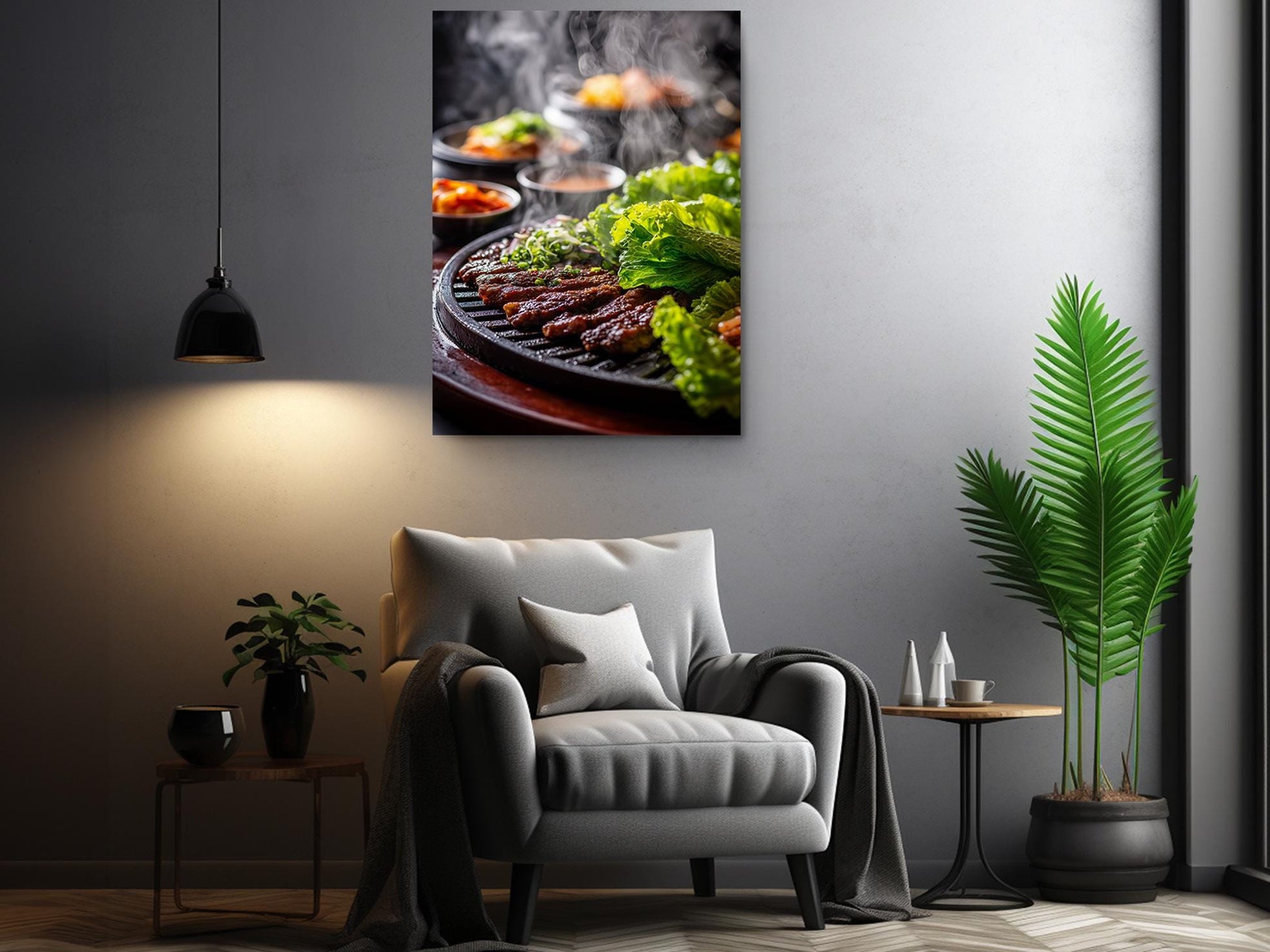 a cozy living room with a comfortable gray armchair, a wooden side table, and a potted plant. Above the armchair, there is a framed photograph of a grill with various food items, including what appears to be grilled vegetables and meat.
