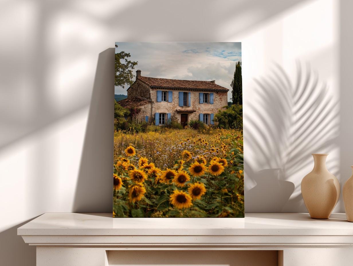 a large, old stone house surrounded by a field of sunflowers.