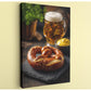 A pretzel with sesame seeds, a glass of beer, and a bowl of mustard are arranged on a dark surface, creating a casual and inviting scene.