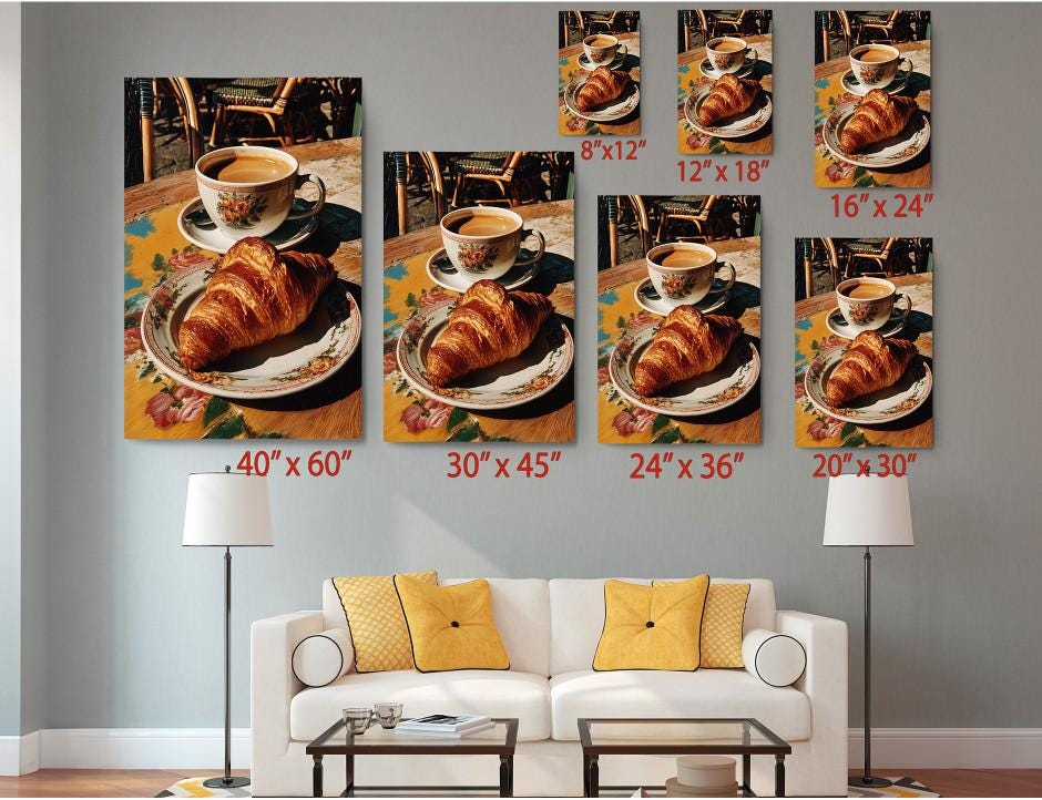 The image is a wall art display featuring a croissant and coffee on a plate, with each size variation labeled to indicate the dimensions of the corresponding canvas.