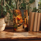 a wooden table with a framed painting of a street scene, surrounded by potted plants and books.